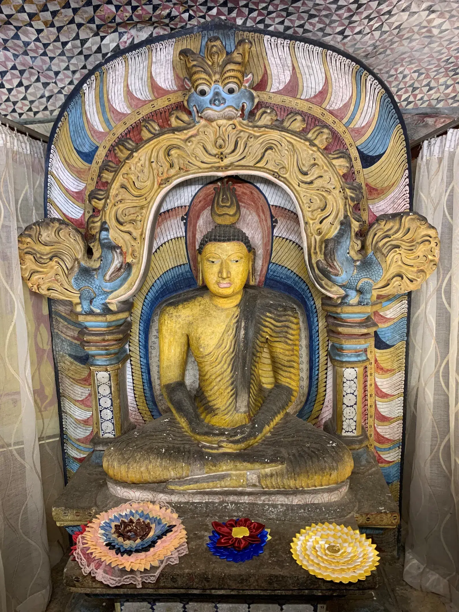 A seated Buddha statue inside the Dambulla cave temple