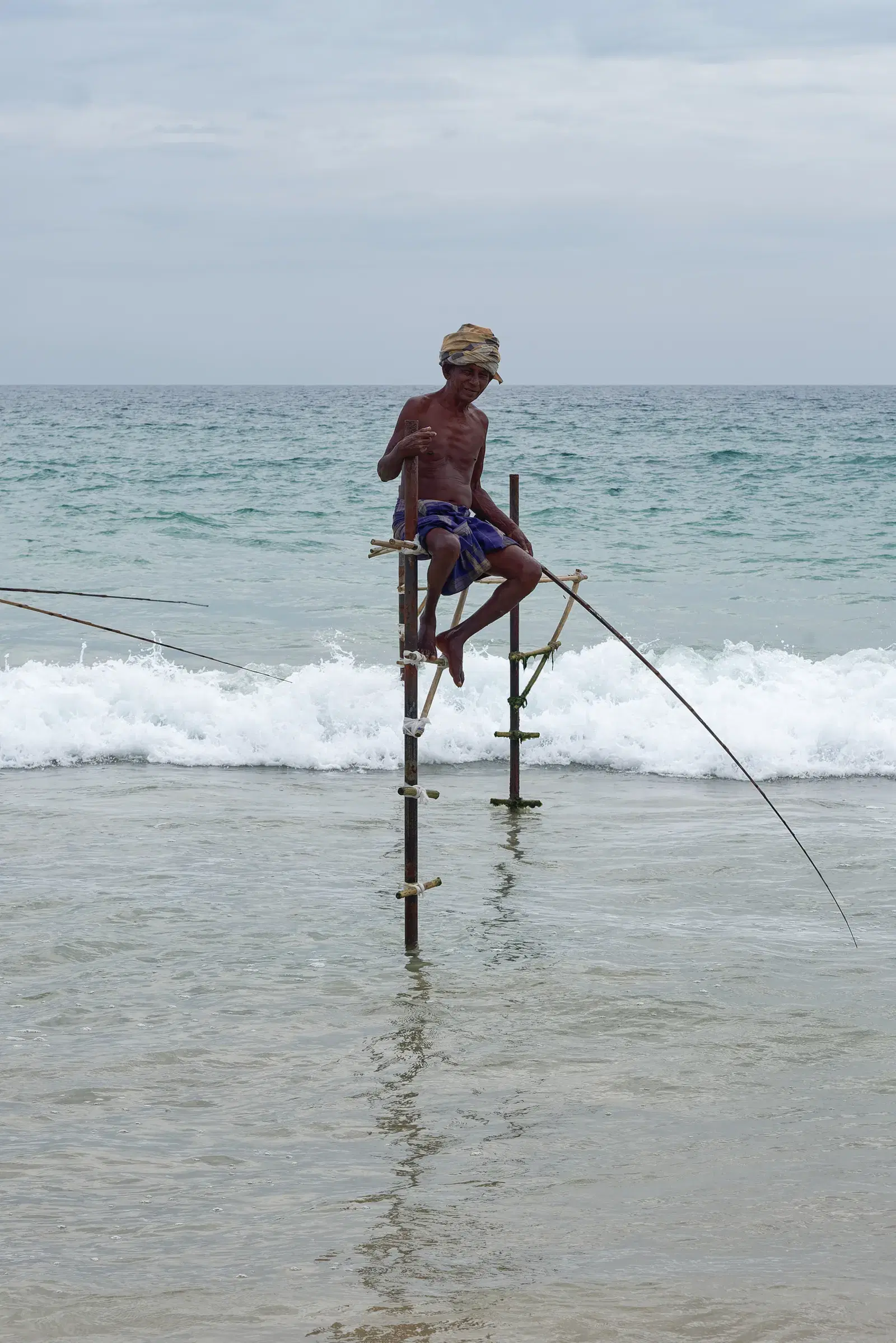 A fisherman demonstrating traditional stilt fishing near Koggala, close to Galle
