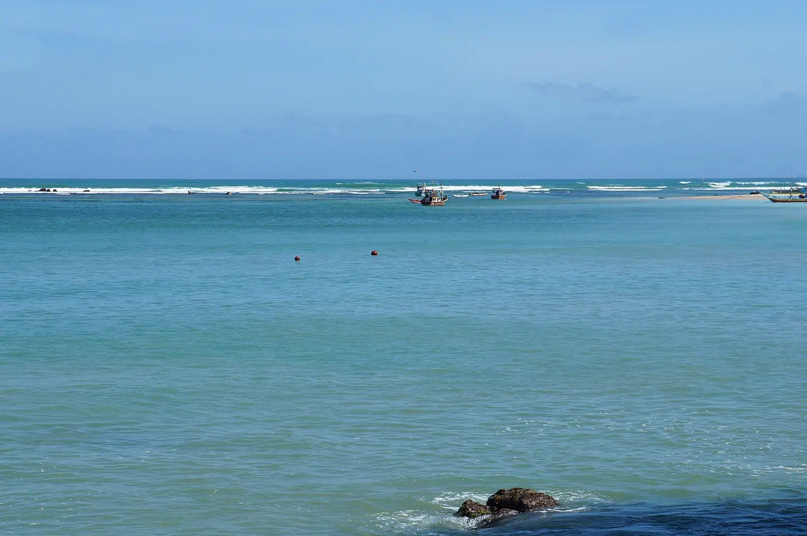 Weligama's wide sandy beach, popular with beginner surfers