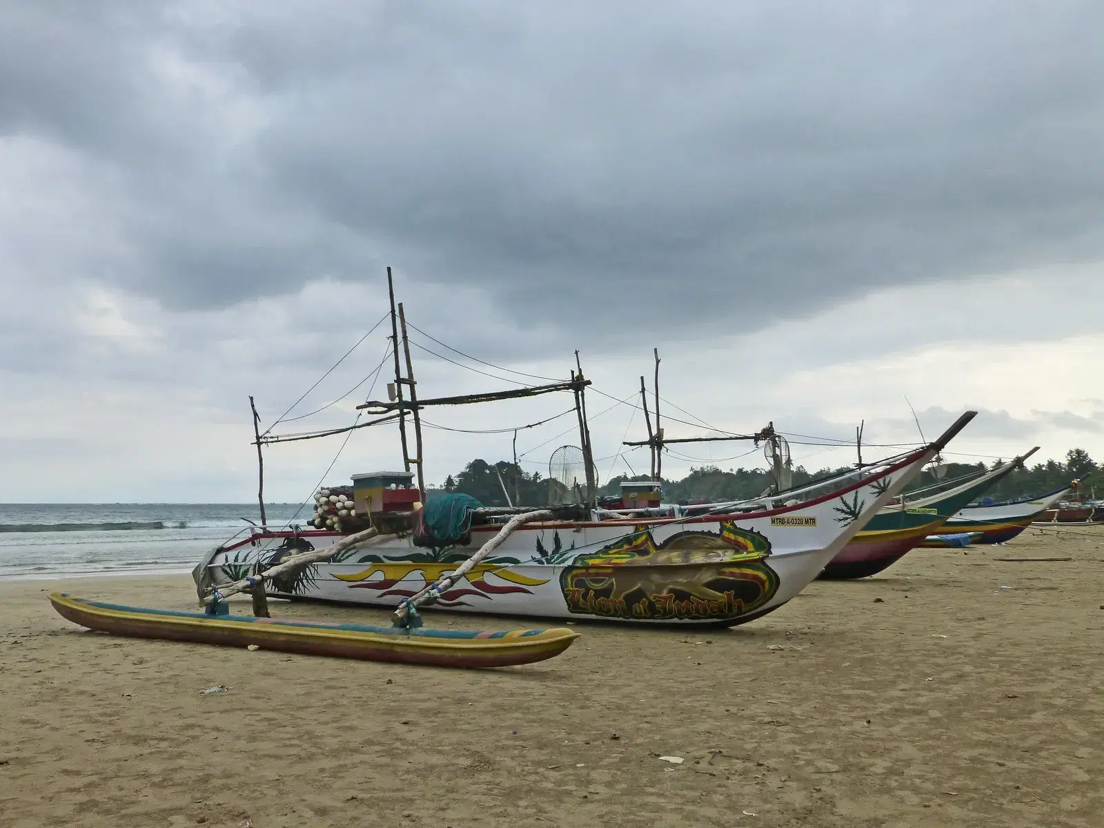 Traditional outrigger boats (pirogues) on the beach at Weligama